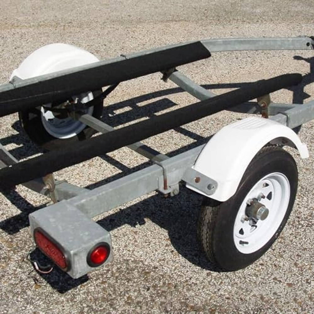 White trailer fender and tire on a single-axle trailer frame