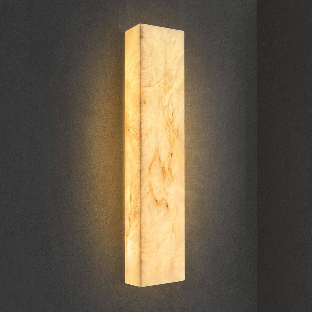 Rectangular natural marble wall sconce with warm amber glow and vertical light panel