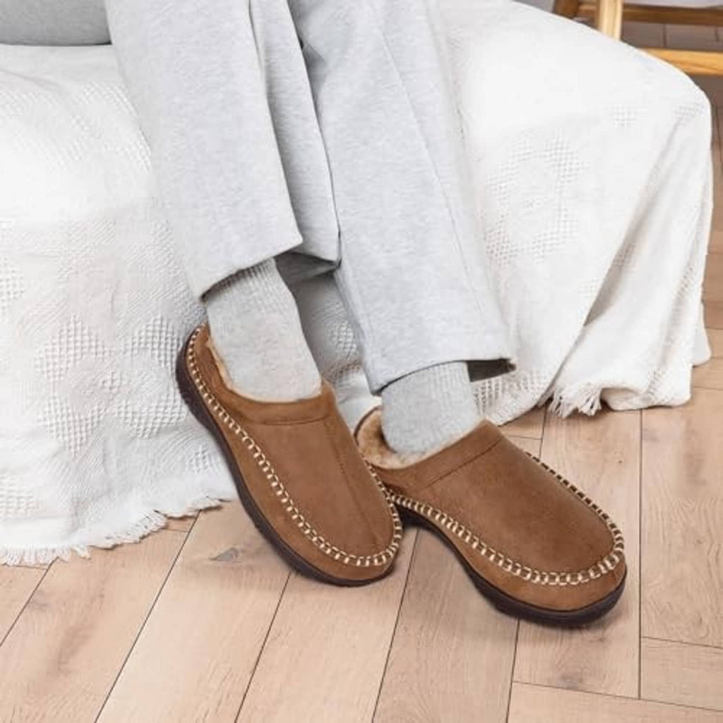 Tan suede moccasin slippers with fuzzy lining and stitched moc toe seams