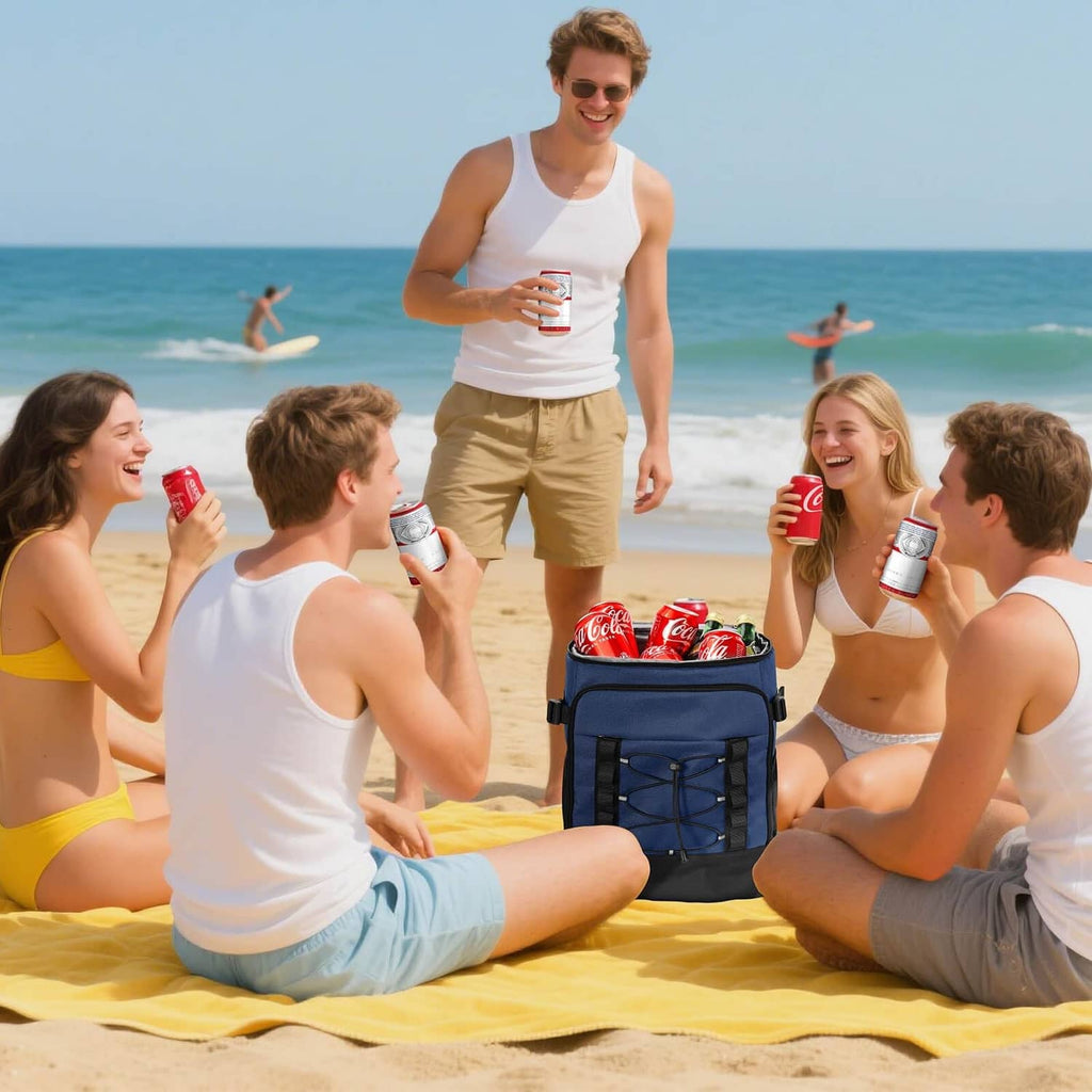 Dark blue insulated cooler backpack on sand with soda cans on top