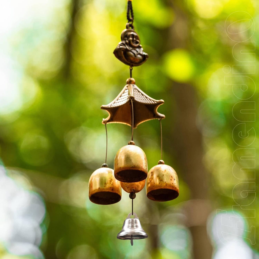 Silver mini jingle bells with loop hooks hanging from a decorative chime