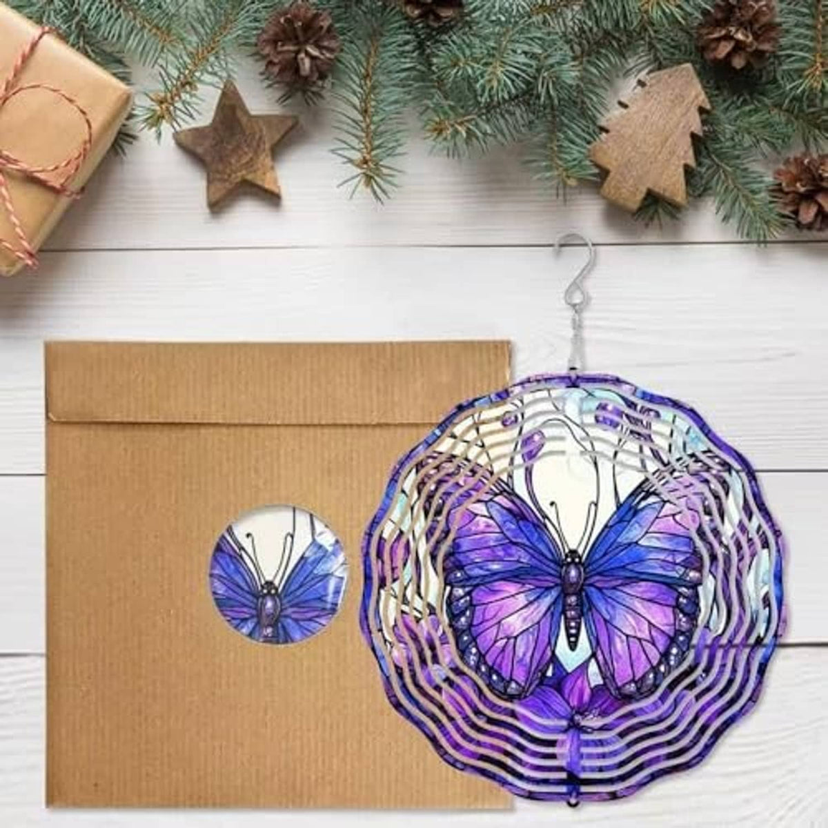 Purple butterfly wind spinner with white spiral rings hanging from a top hook