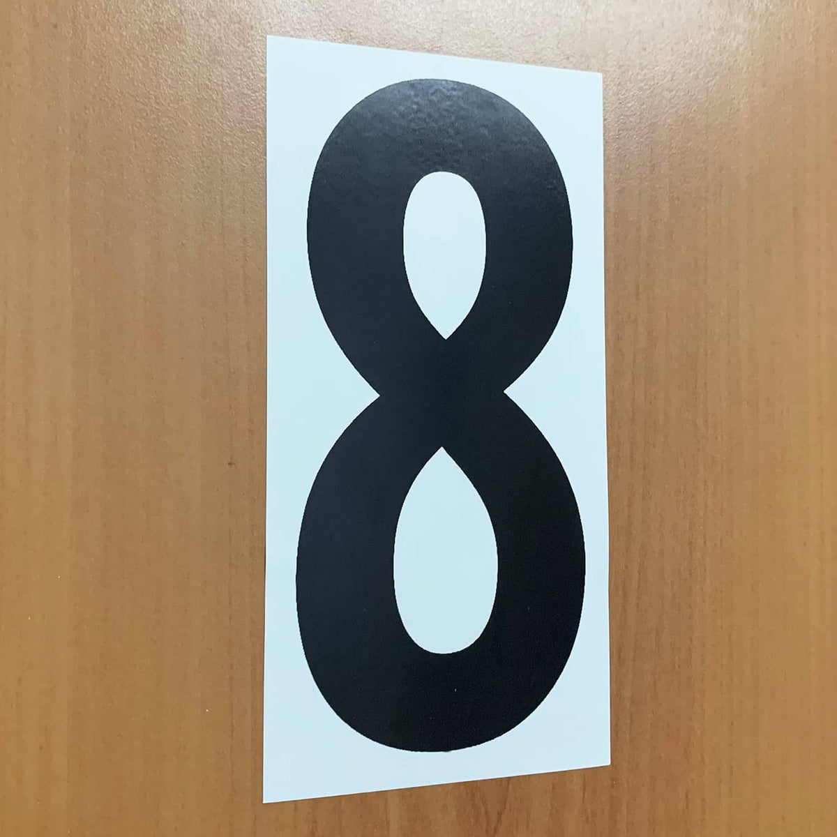 Black vinyl number sticker, large “8” on white backing