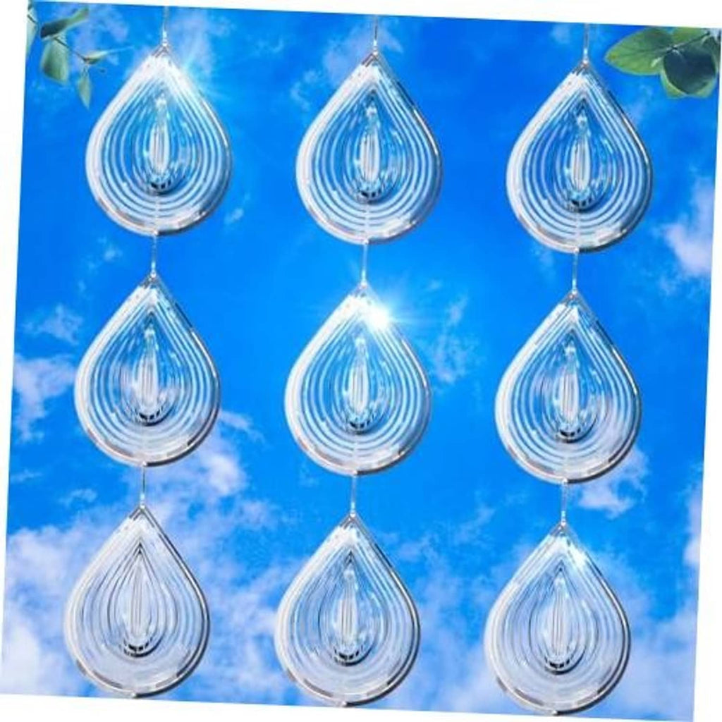 Multiple silver reflective teardrop bird scare discs hanging with bright water-droplet highlights