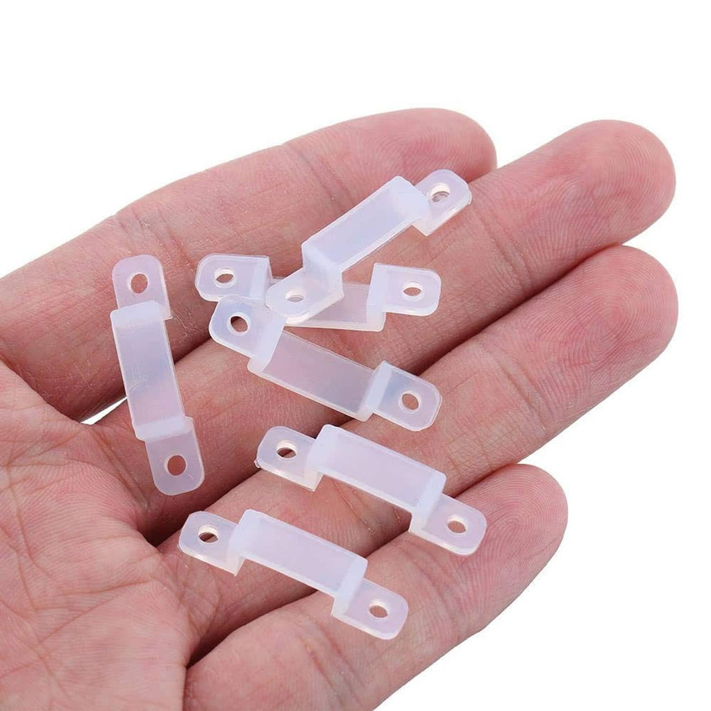 White 12mm LED strip mounting brackets held in hand, multi-piece set