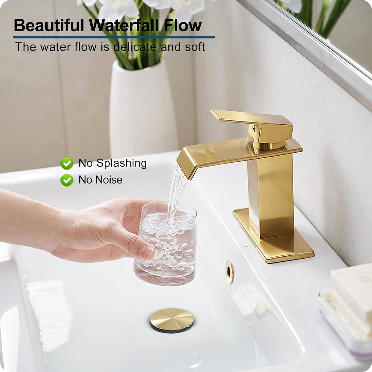 Gold single-handle bathroom faucet with waterfall spout, water streaming into tub