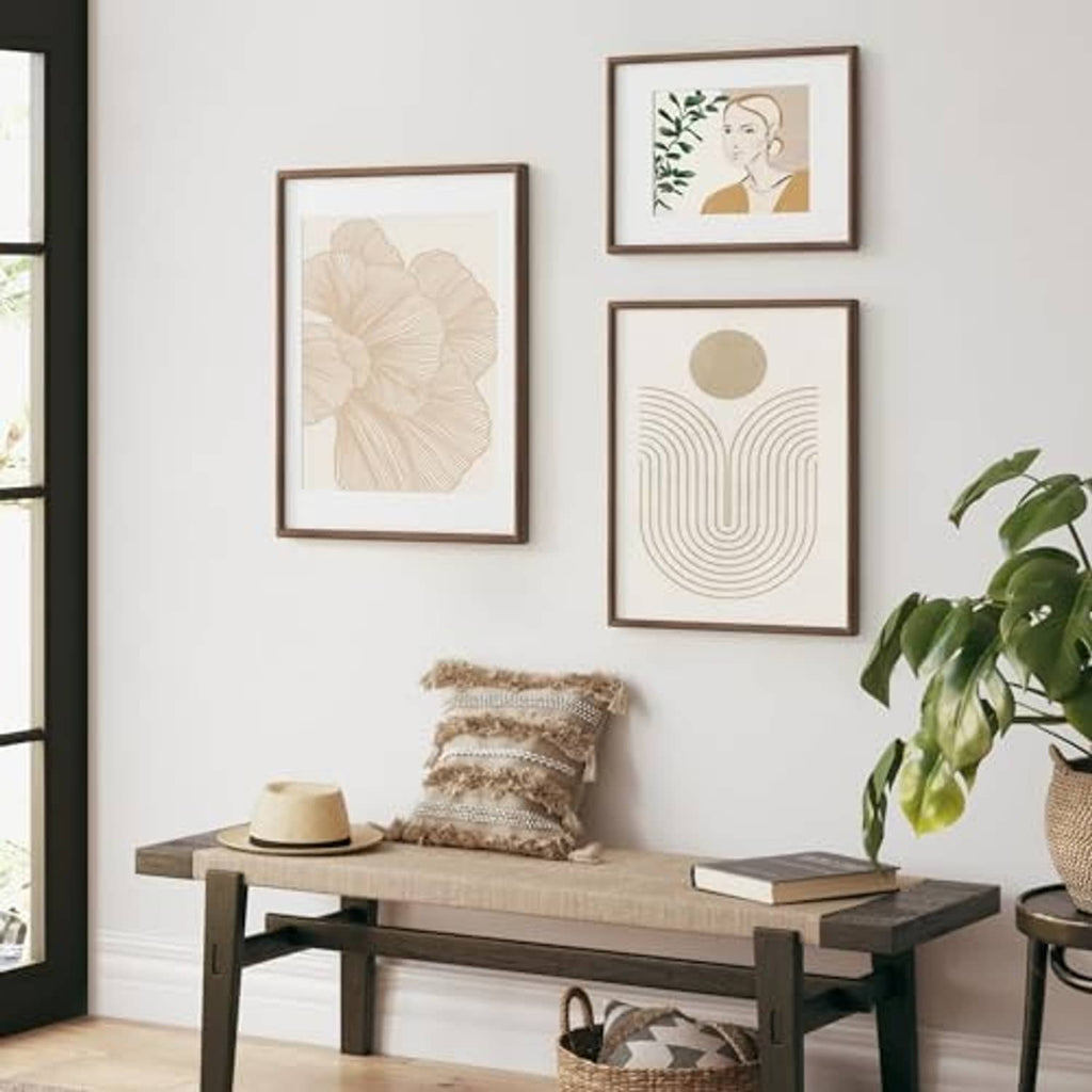 Walnut picture frames set on wall with botanical and abstract prints, front view