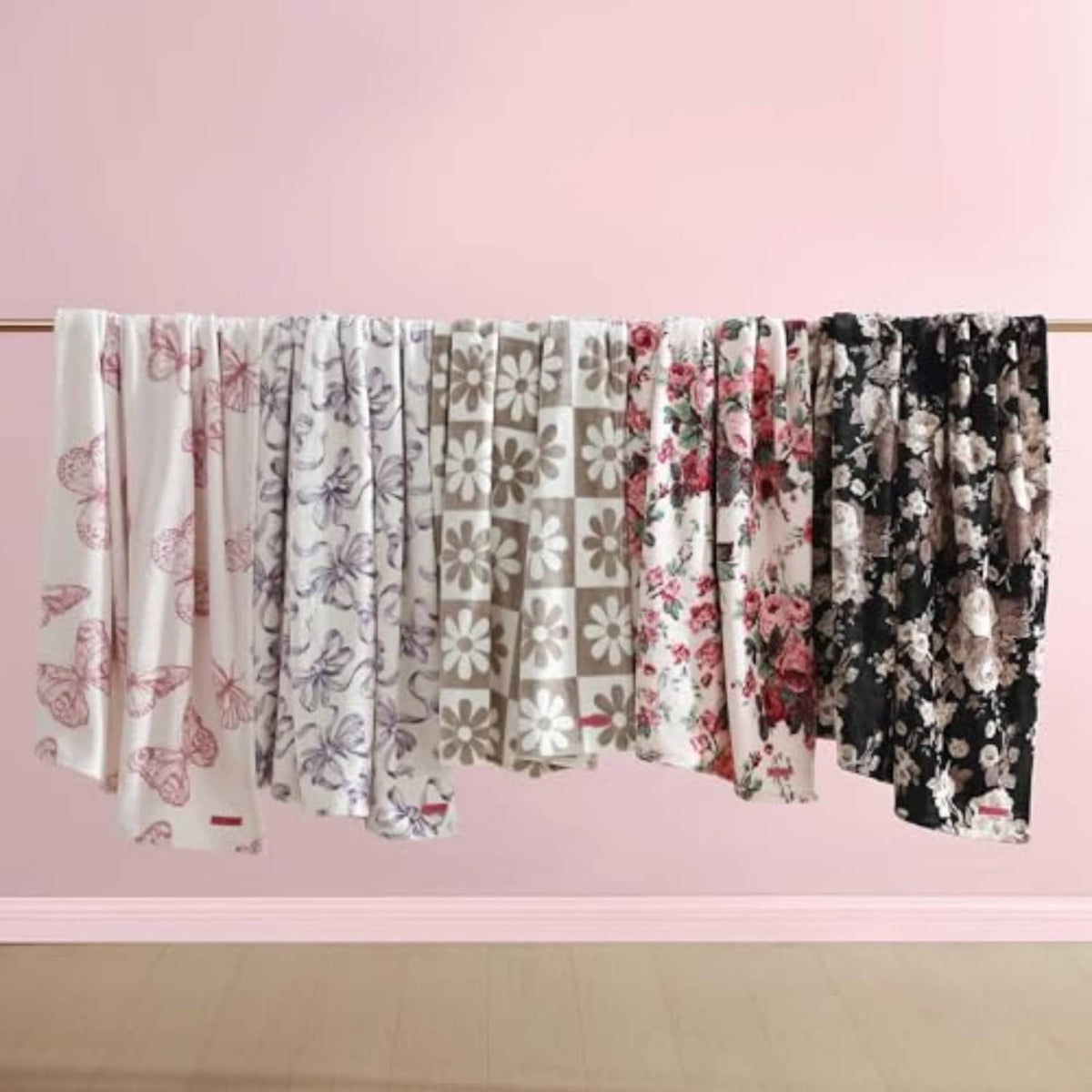 Hanging folded blankets with mixed floral and butterfly patterns