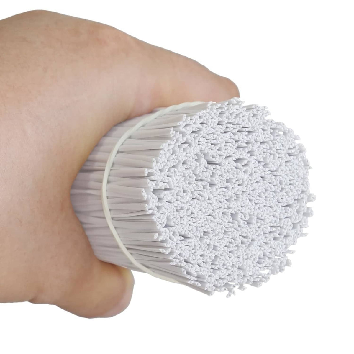 White plastic twist ties with metal core, fanned strands held in hand