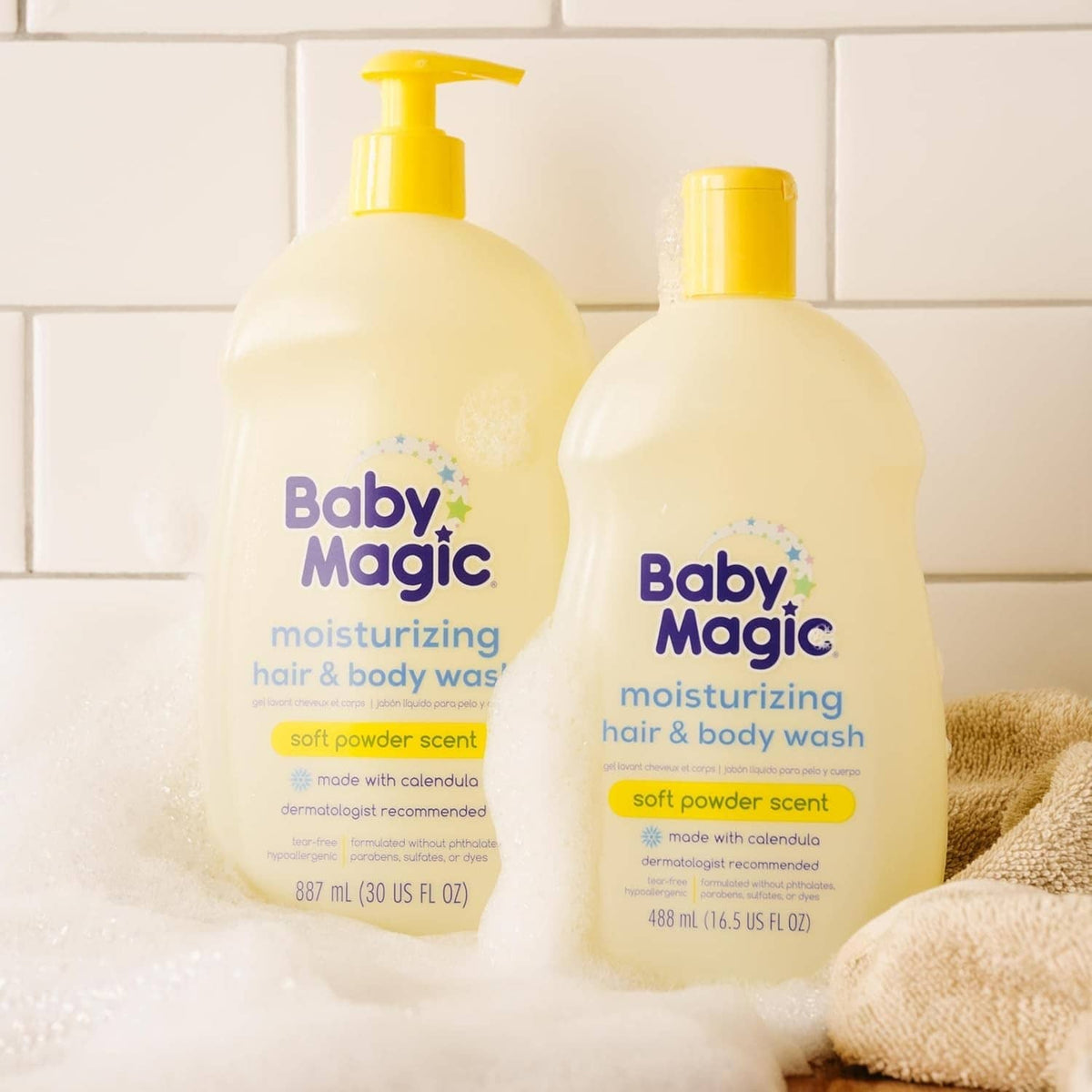 Baby Magic moisturizing hair & body wash bottles with pump, soft powder scent.