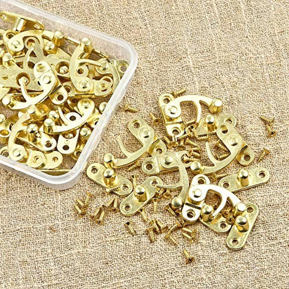 Antique gold jewelry box hardware set with latch plates and screws in clear box