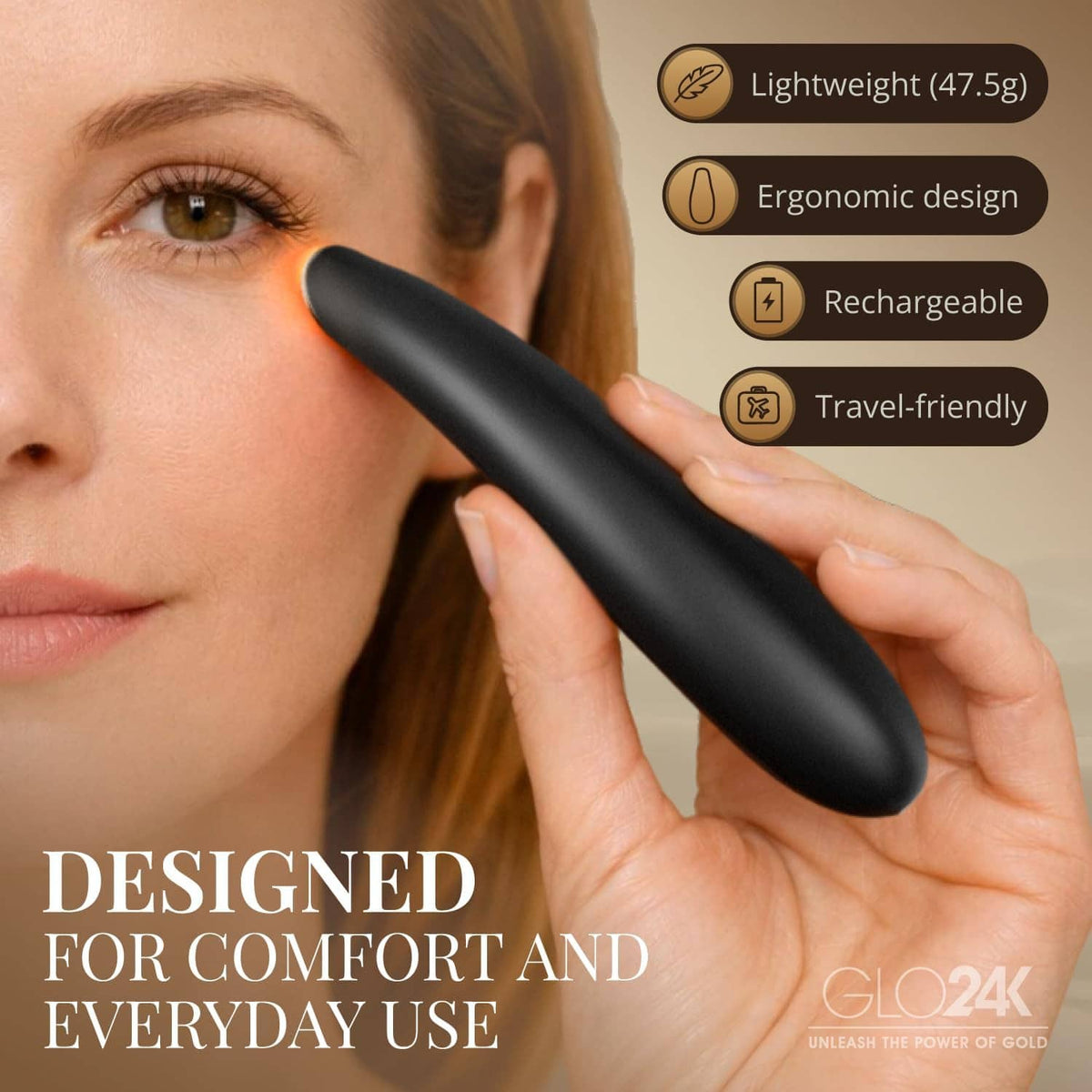 GLO24K heated eye wand held to the eye area, black device with display lights