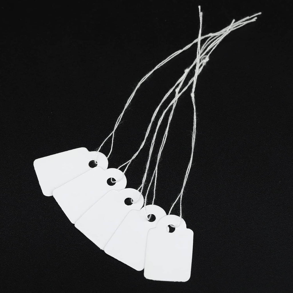 White price tags with string loops and round holes, hanging on multiple cords
