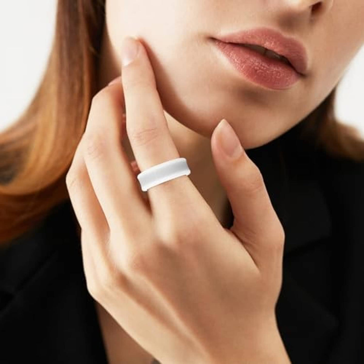 White silicone ring cover on finger with metal interior ring