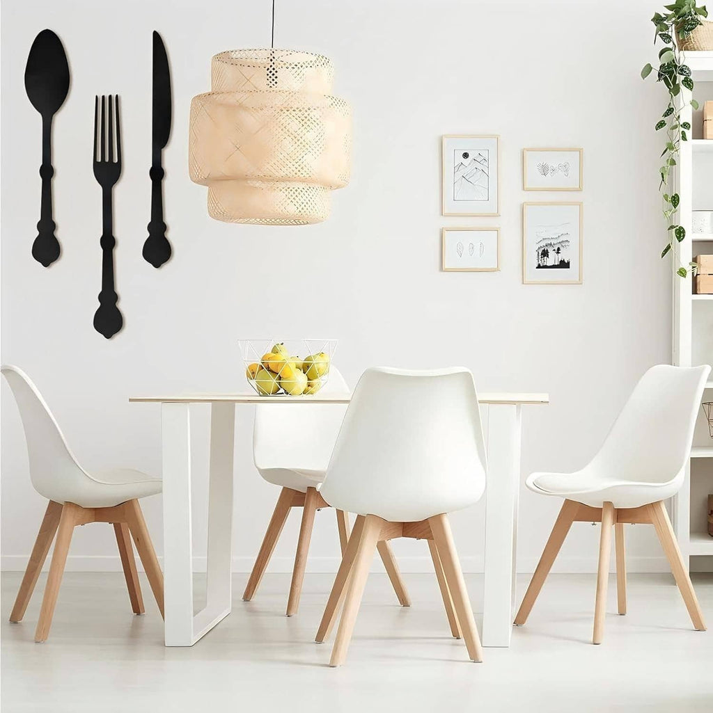 Black wooden knife, fork, and spoon wall decor set displayed on a dining wall.