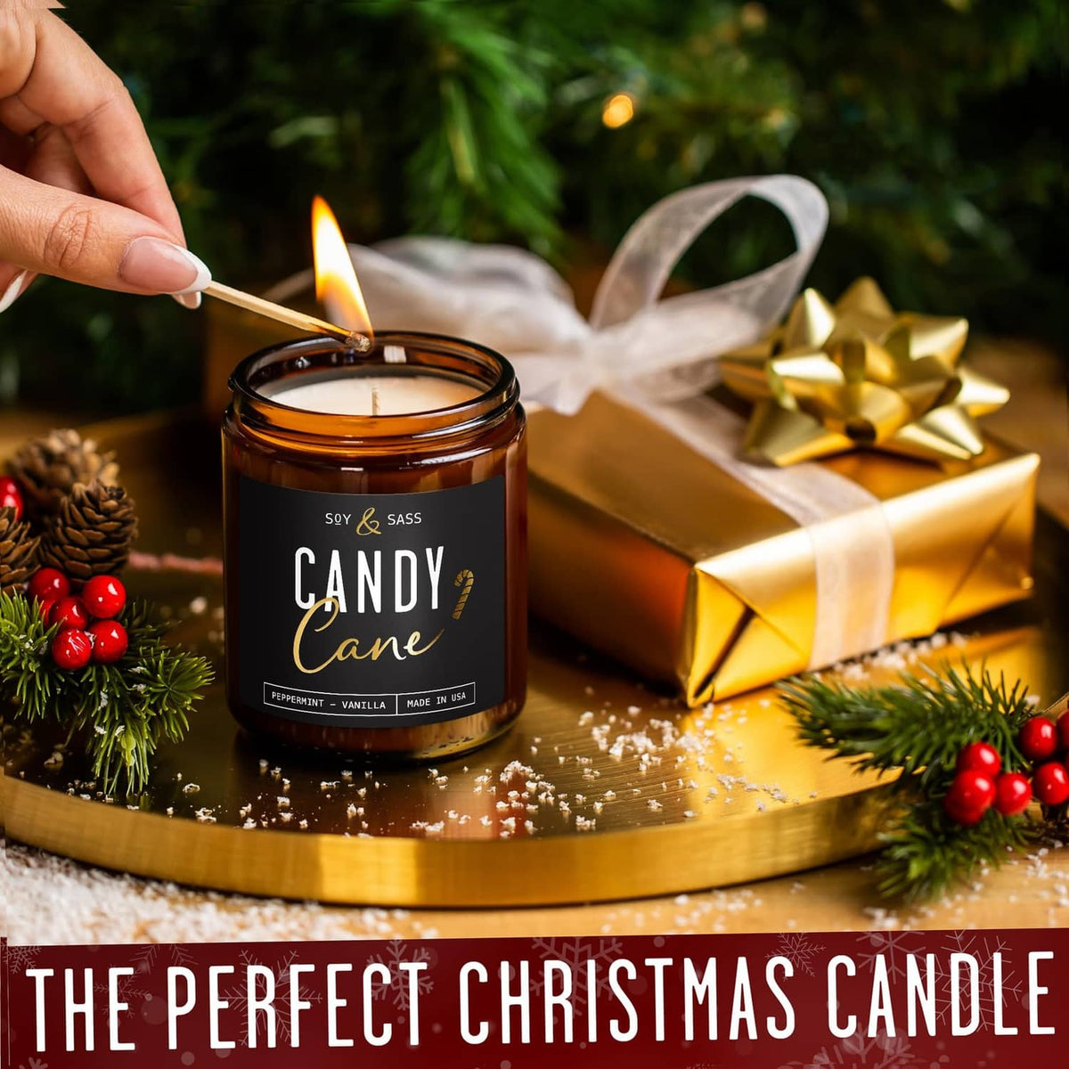 Amber glass “Candy Cane” candle jar with open flame, soy & sass label on a tray