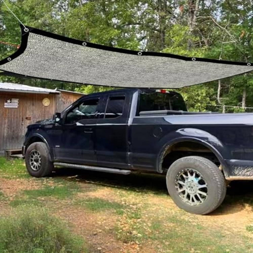 Gray mesh shade cloth stretched over a pickup truck bed with black mounting frame