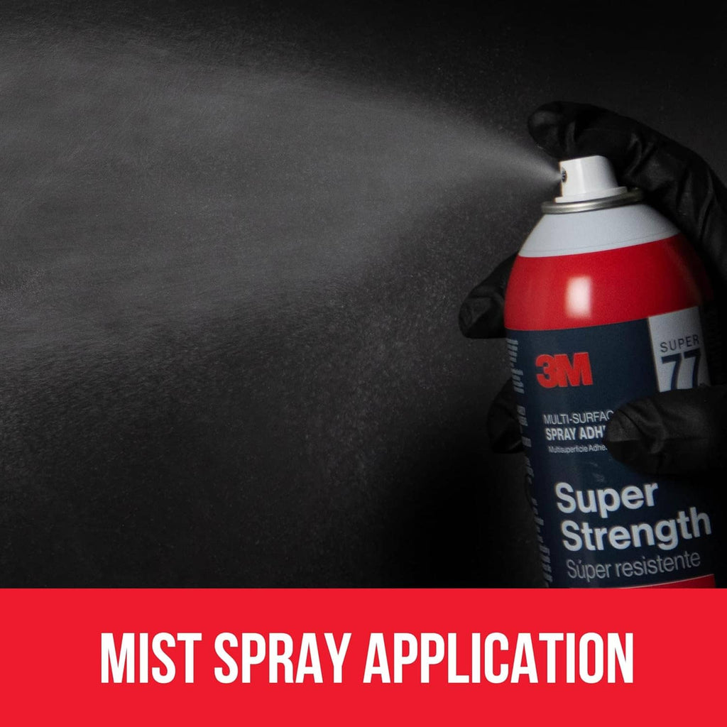 Red-and-black spray adhesive can with nozzle held by a gloved hand