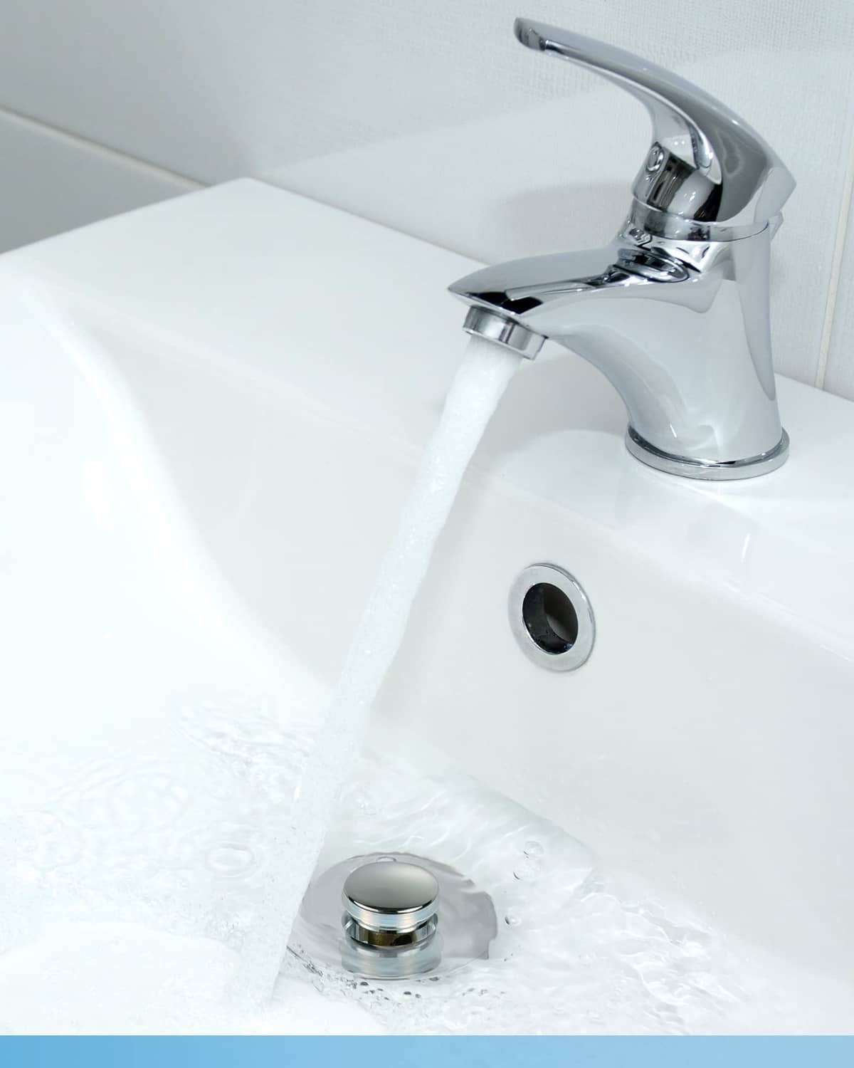 Chrome bathroom sink drain stopper in place with pop-up strainer and brass fitting