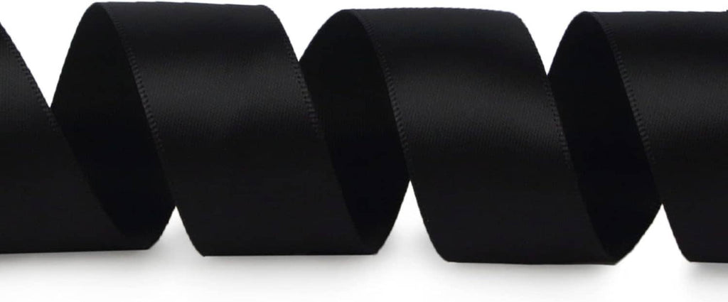 Black satin ribbon from a roll, shown in close-up ribbon loops