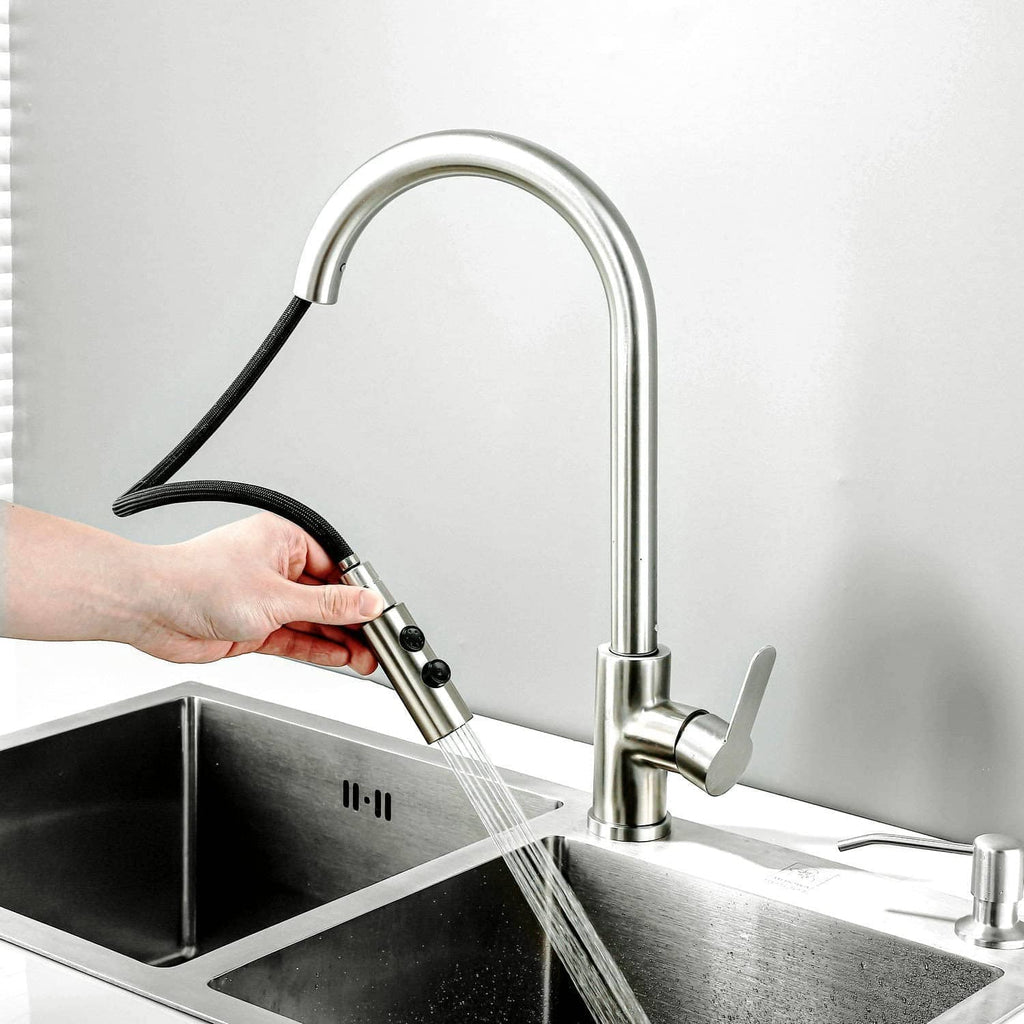Pull-down kitchen faucet with handheld sprayer spraying water over sink