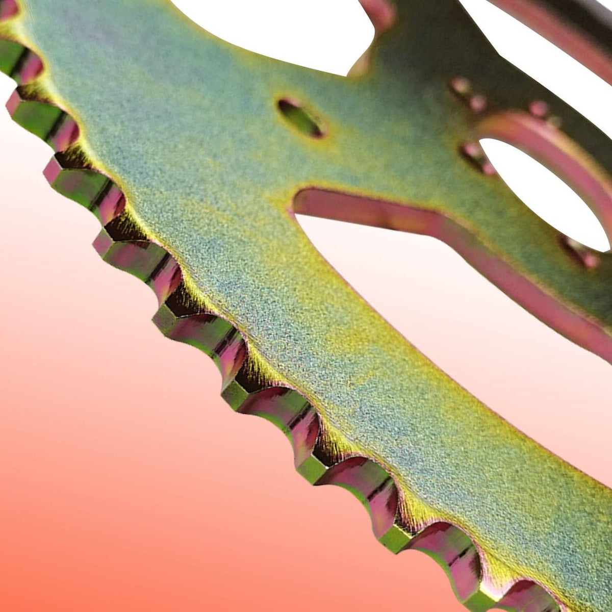 Close-up of rainbow-coated sprocket teeth on a 60T rear chain sprocket