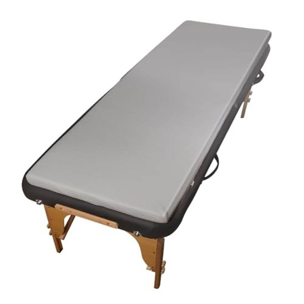 Grey padded massage table topper with dark edging and elastic straps for a snug fit