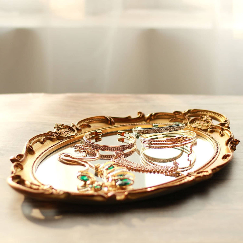 Gold oval decorative tray with assorted rhinestone and beaded bracelets