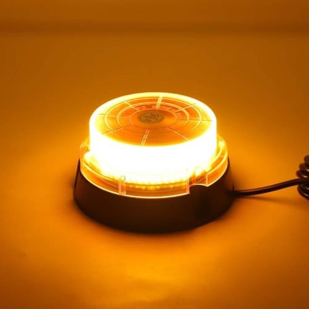 Amber LED strobe beacon light glowing on black base with attached power cable