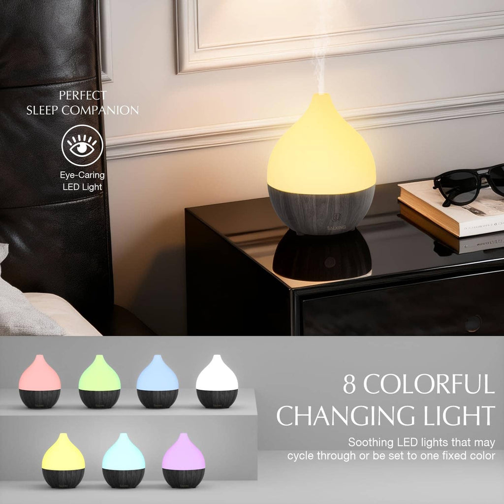 Ultrasonic essential oil diffuser with glowing yellow LED light and visible mist plume