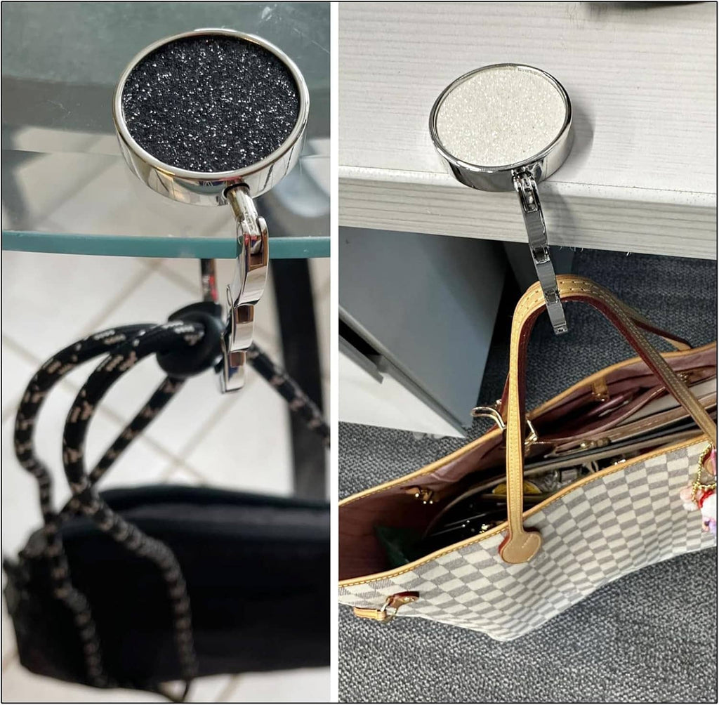 Foldable purse hook mounted on table; handbag strap hangs from chrome hook