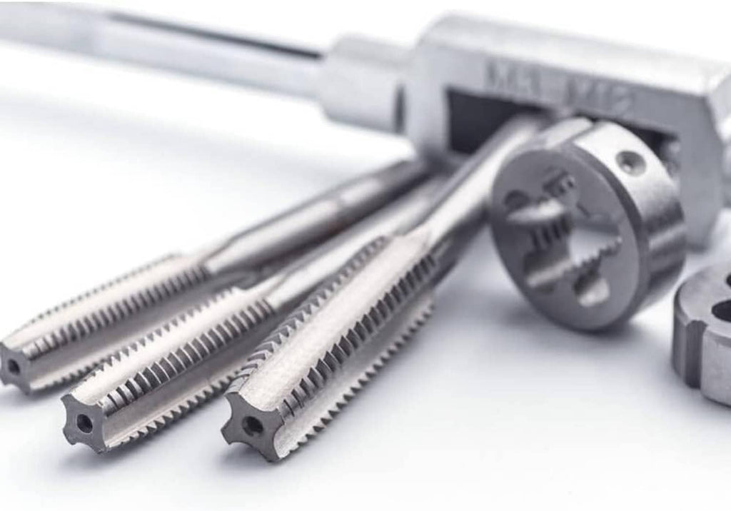 Metric thread taps in a holder, silvery shanks and cutting ends visible