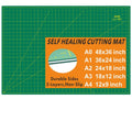 Green self-healing cutting mat with grid lines and corner measurement markers