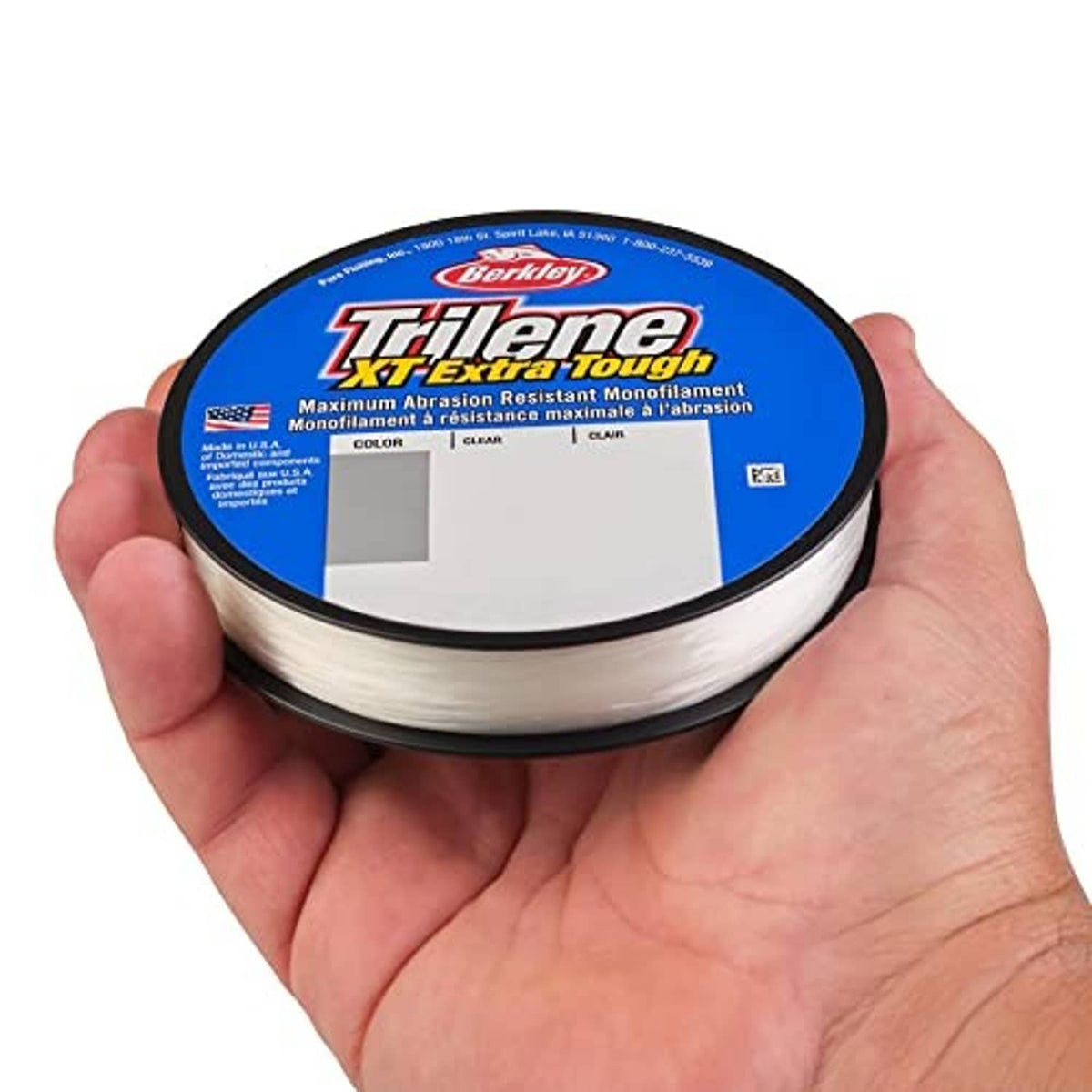 Clear monofilament fishing line spool held in hand with blue XT Extra Tough label