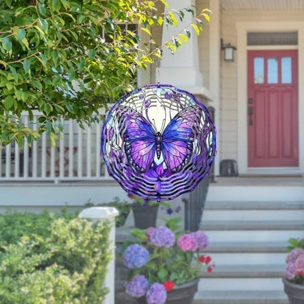 Purple butterfly wind spinner with white spiral rings hanging on outdoor porch