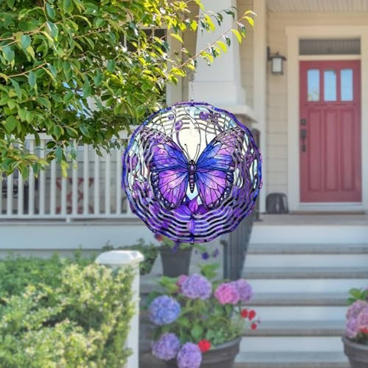 Purple butterfly wind spinner with white spiral rings hanging on outdoor porch