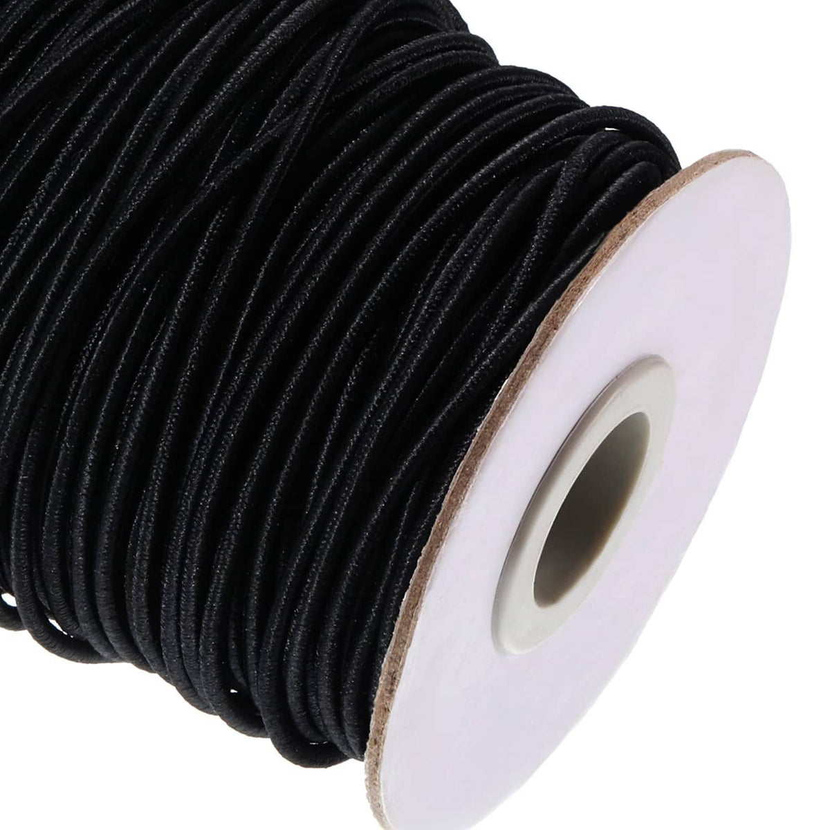 Close-up of black elastic cord detail on white spool backing