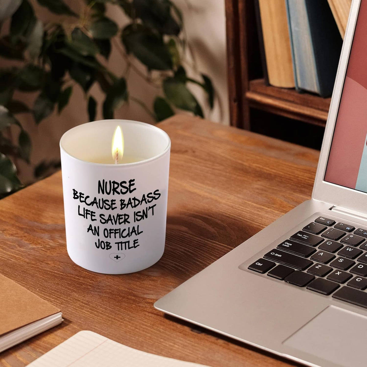 White lit candle jar, 'NURSE BECAUSE BADASS...' quote with plus icon