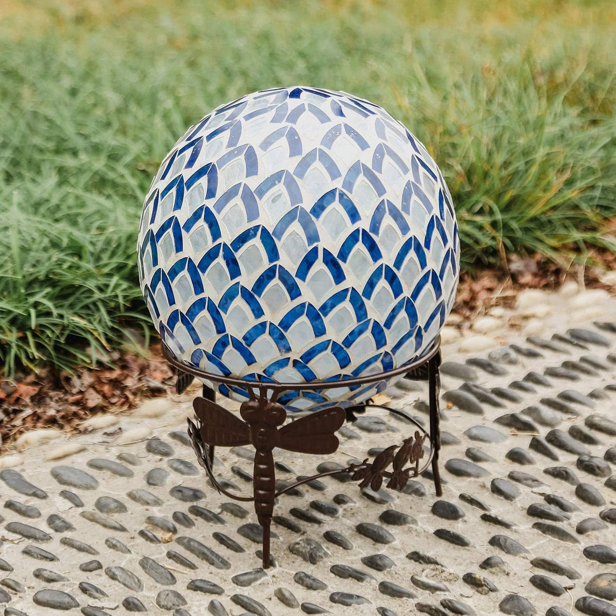 Metal gazing ball stand with blue mosaic gazing ball on curved spiral base.