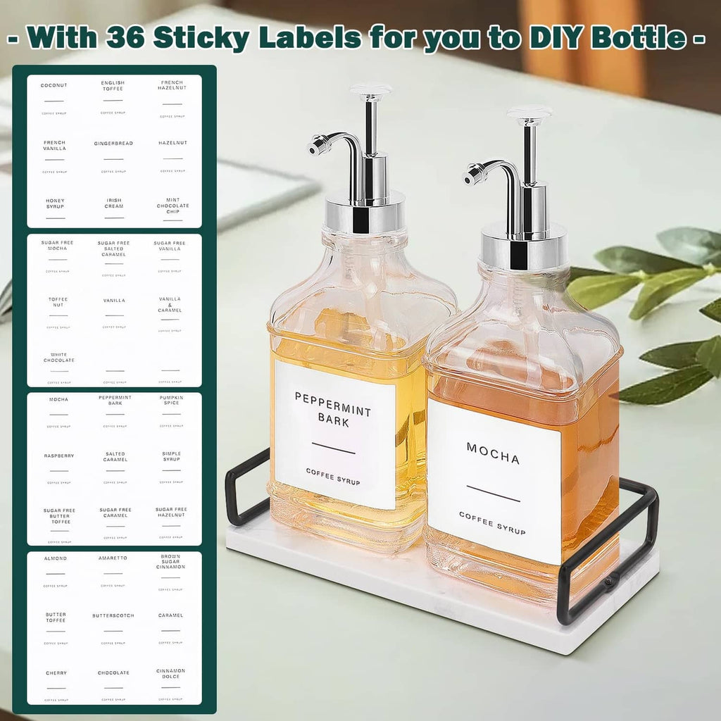 Glass coffee syrup dispenser set with two amber-filled bottles, chrome pumps, tray
