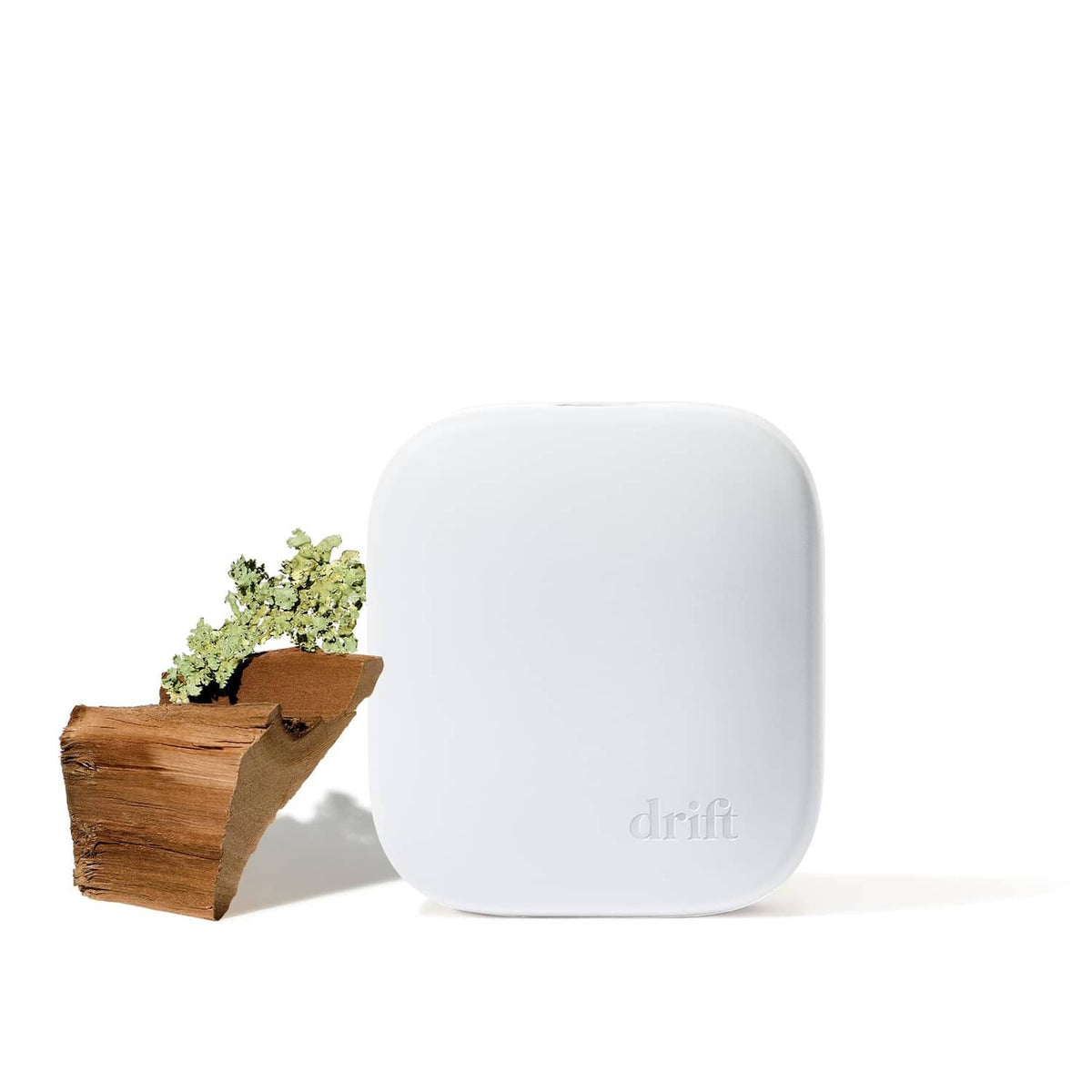 White plug-in scent diffuser with teak holder and small greenery accessory
