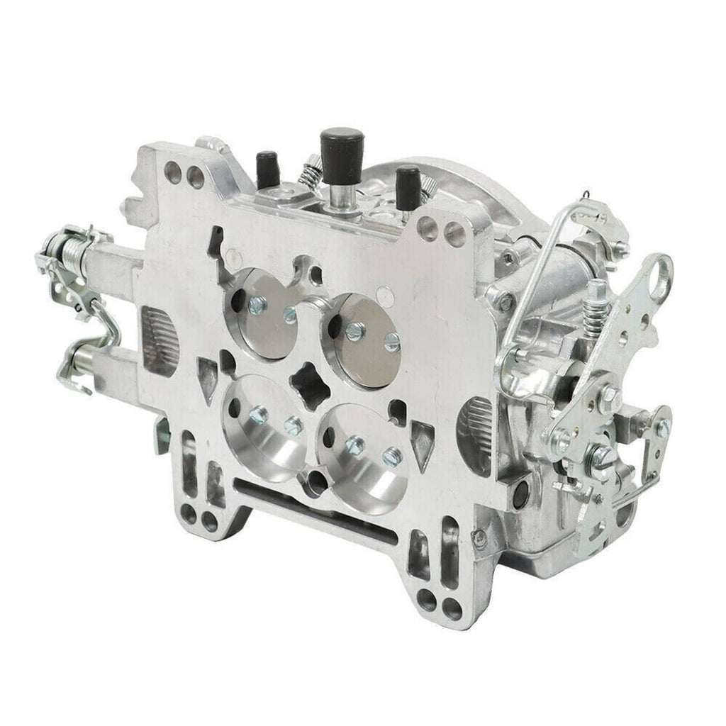 Four-barrel carburetor underside view with machined ports and mounting points
