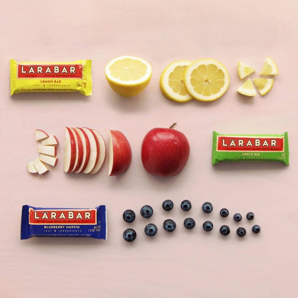 Lemon and apple pie bar wrappers with citrus halves and apple slices