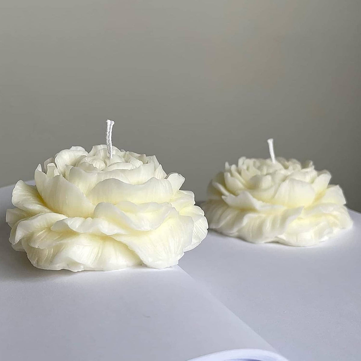 White peony-style flower candles, two pieces with exposed wicks