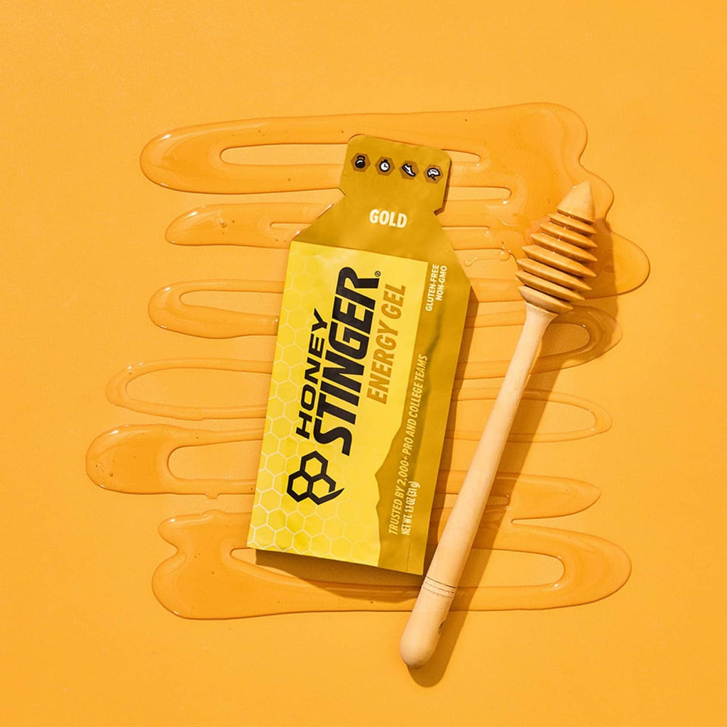 Gold energy gel packet with honey dipper-shaped applicator