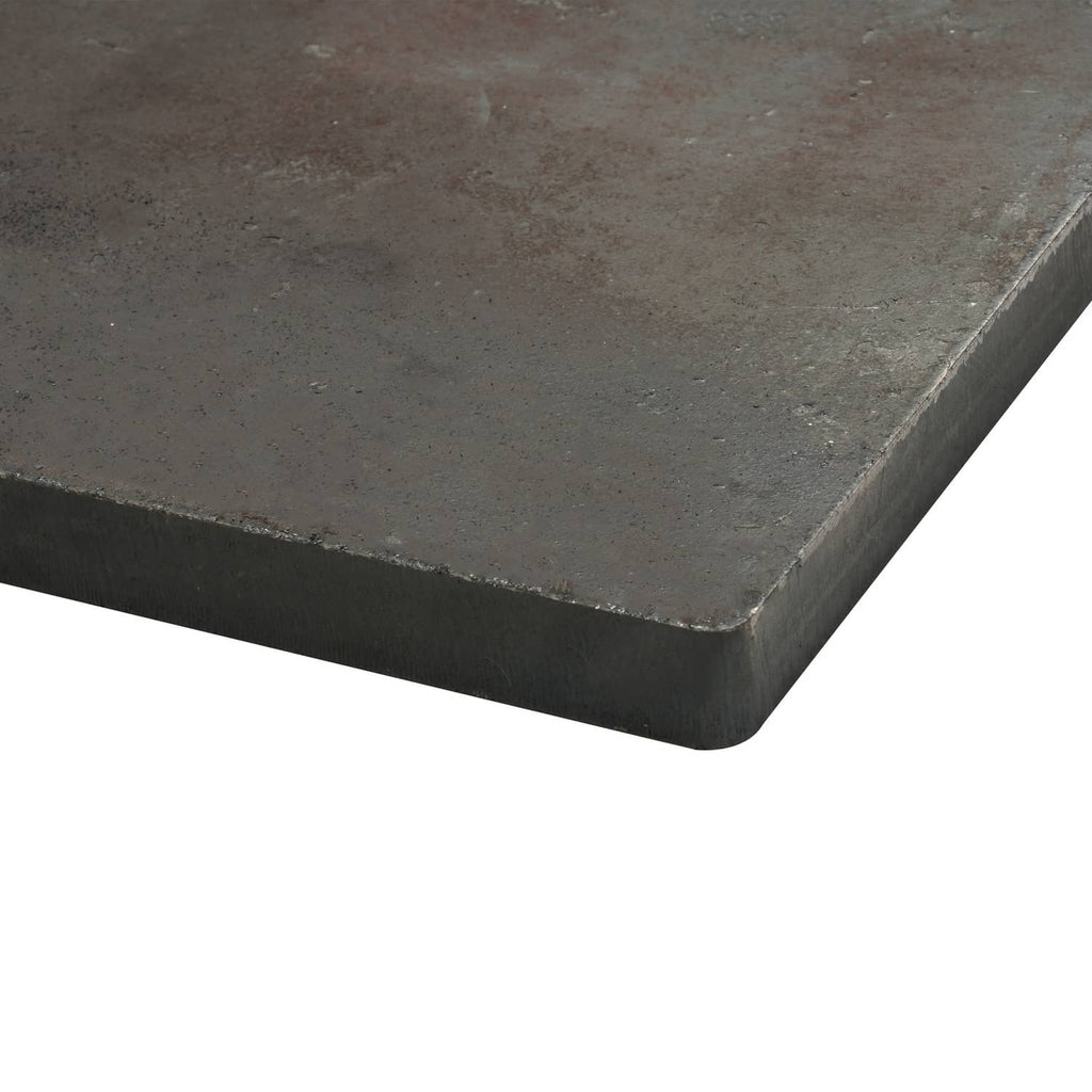 Close-up of steel base plate with beveled edge and dark textured finish