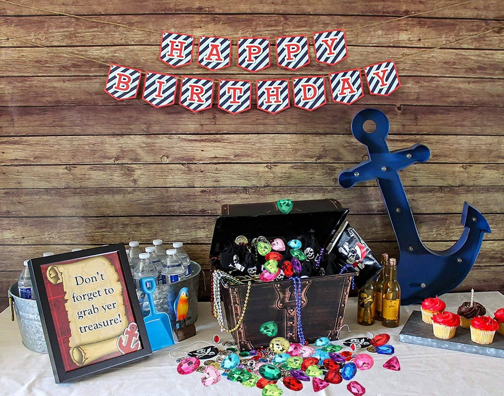 Open pirate-style treasure chest with scattered multi-colored faceted jewel stones
