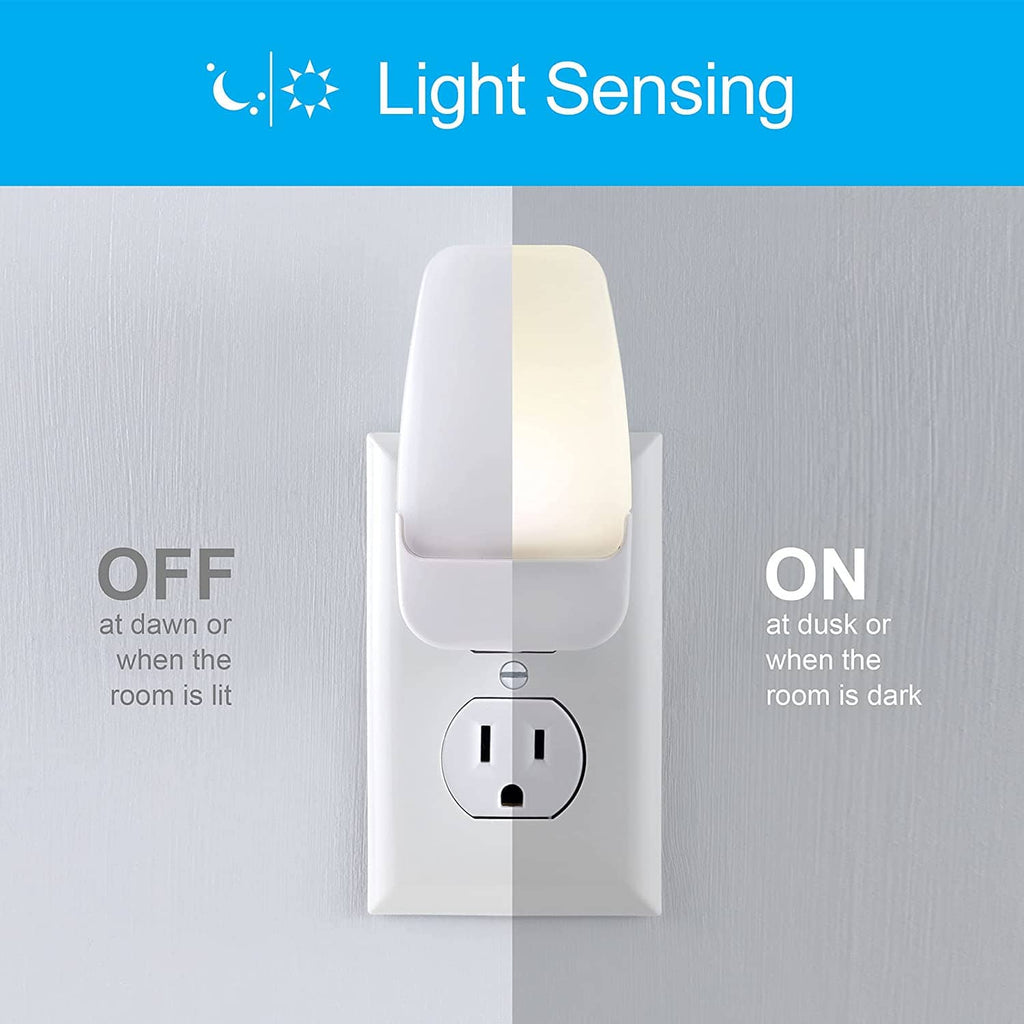 Plug-in light-sensing LED night light with warm white glow on wall outlet