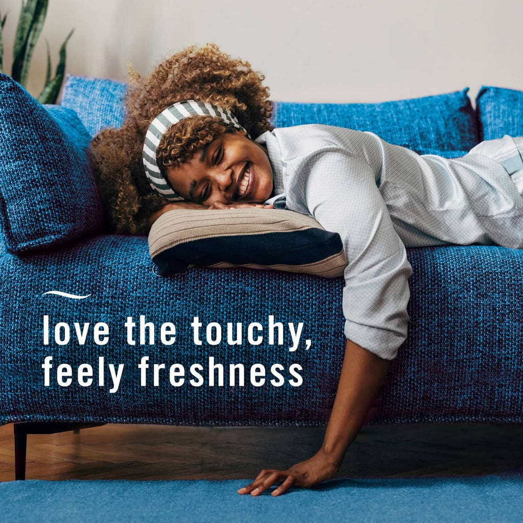 Fabric freshness spray lifestyle scene with person resting on couch