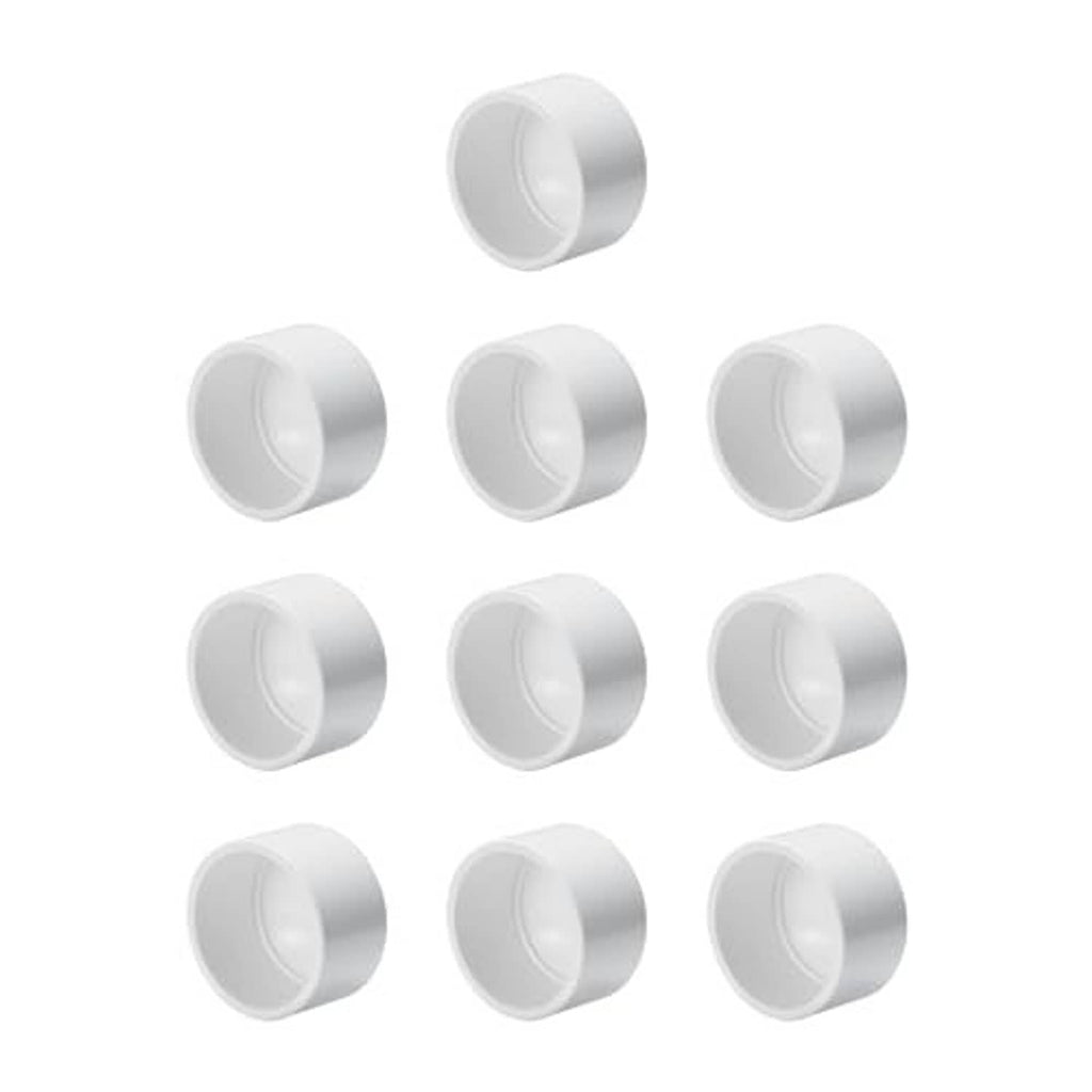 White PVC schedule 40 end caps, multiple pieces arranged with round openings